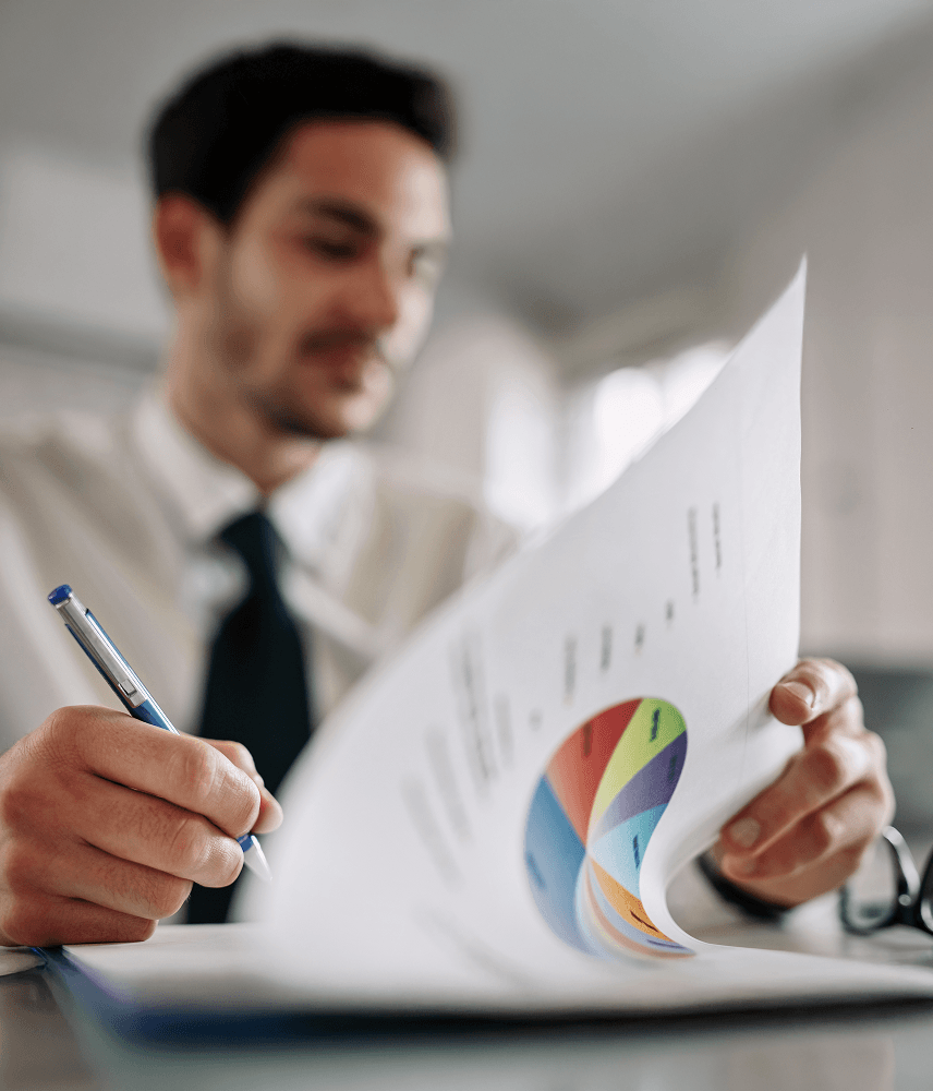 close-up-entrepreneur-going-through-business-reports-taking-notes-office 2.png